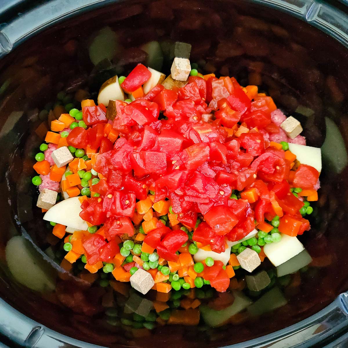 Diced tomatoes added to crockpot.