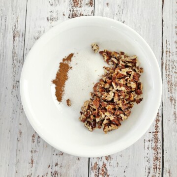 Small bowl with cinnamon, sugar, and chopped pecans.