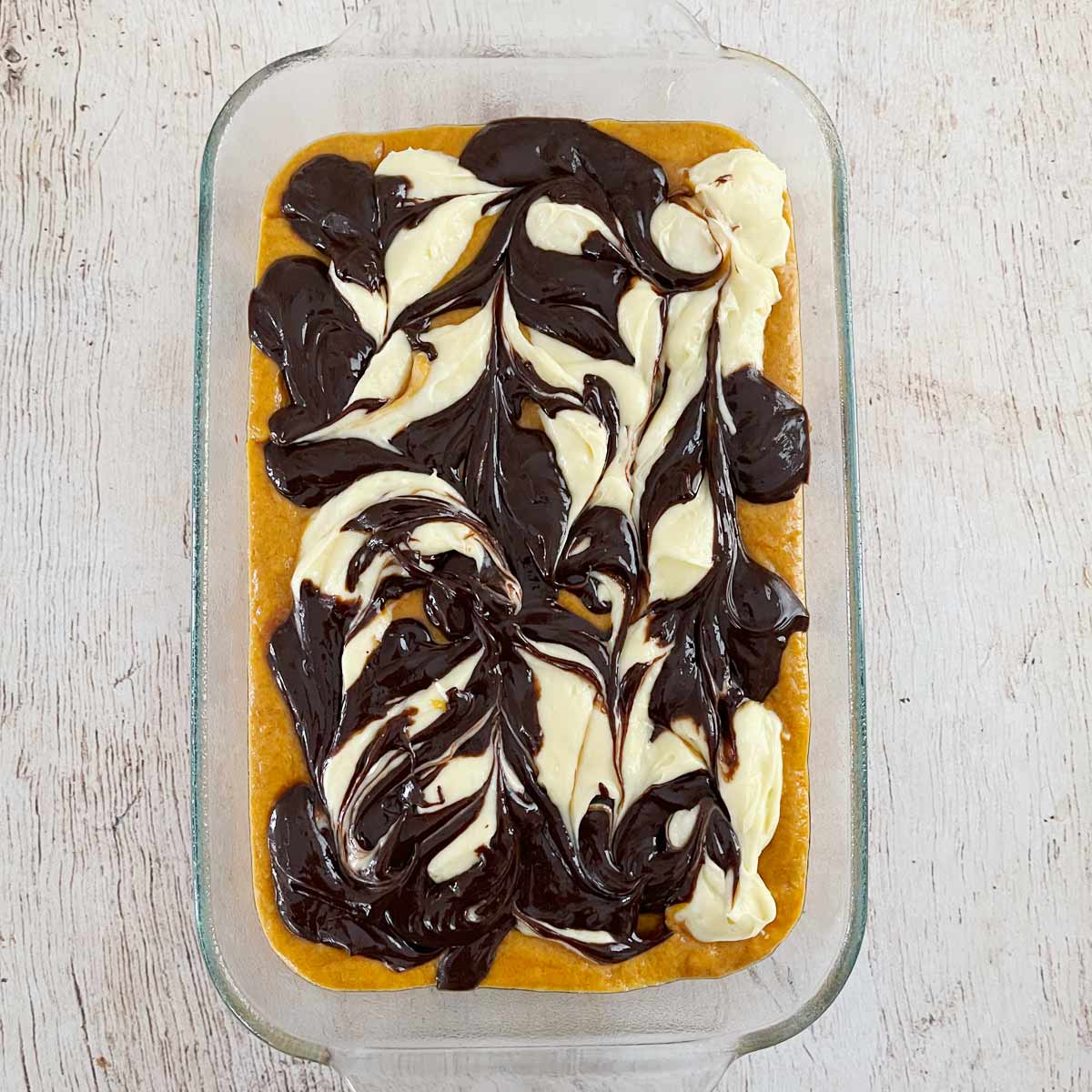 Baking dish with swirled layers of cake, cream cheese, and chocolate.