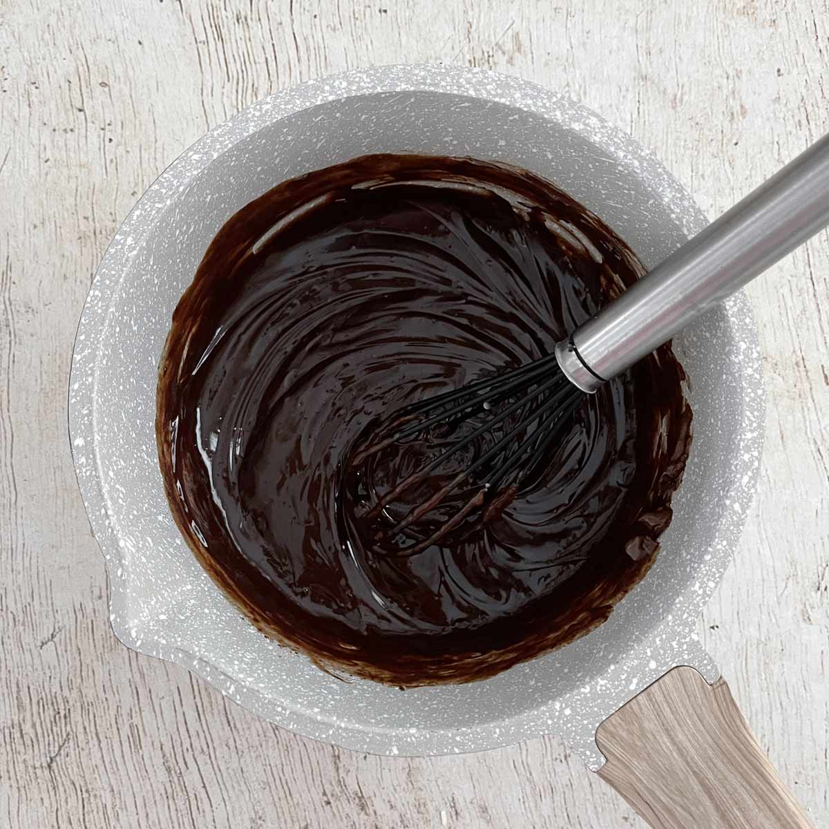 Saucepan with melted chocolate ganache.