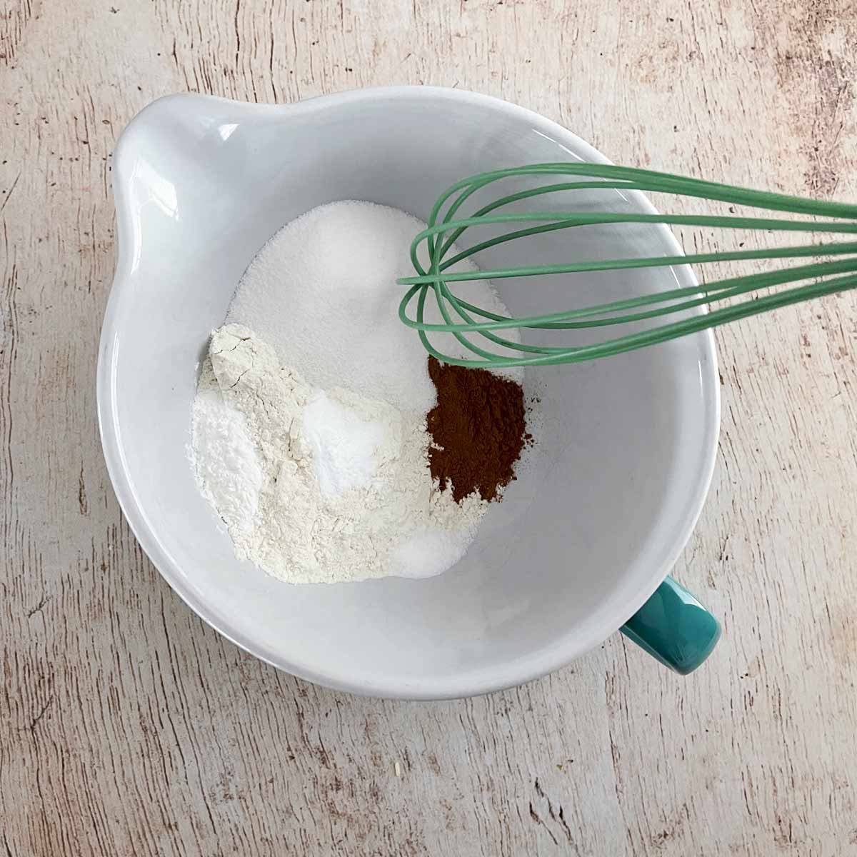 Dry ingredients (flour, remaining sugar, cinnamon, baking powder. baking soda & salt) in a mixing bowl.