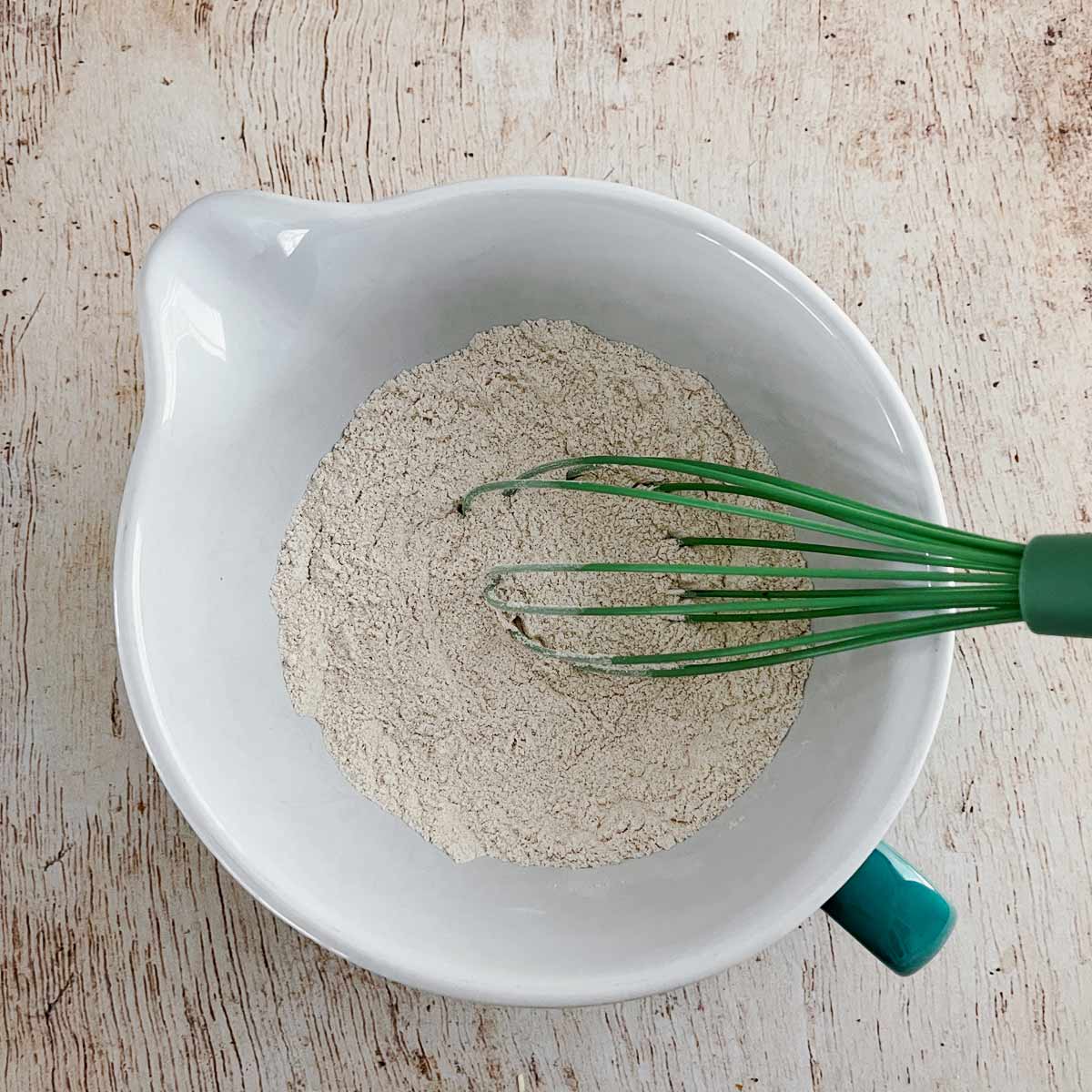 Whisking the dry ingredients in a large mixing bowl.