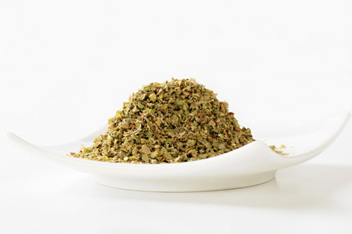 Curved plate with dried marjoram.
