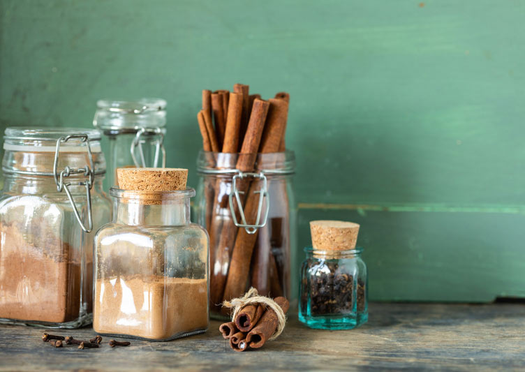 Jars with spices and cinnamon sticks.