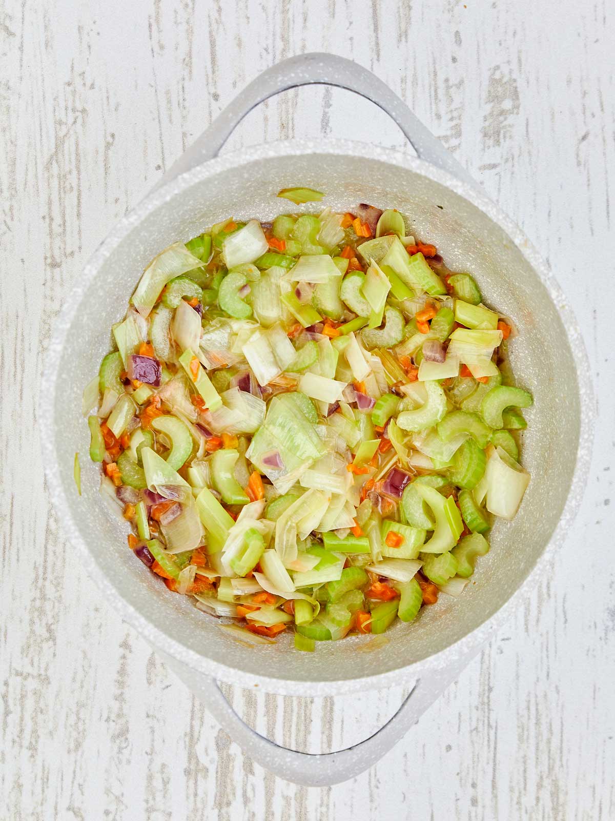 Softened vegetables in the pot.