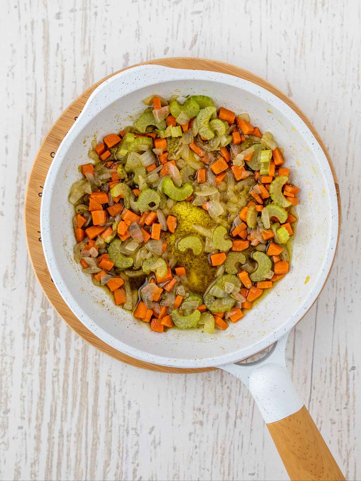 Cooked veggies with cooked seasonings in the skillet.