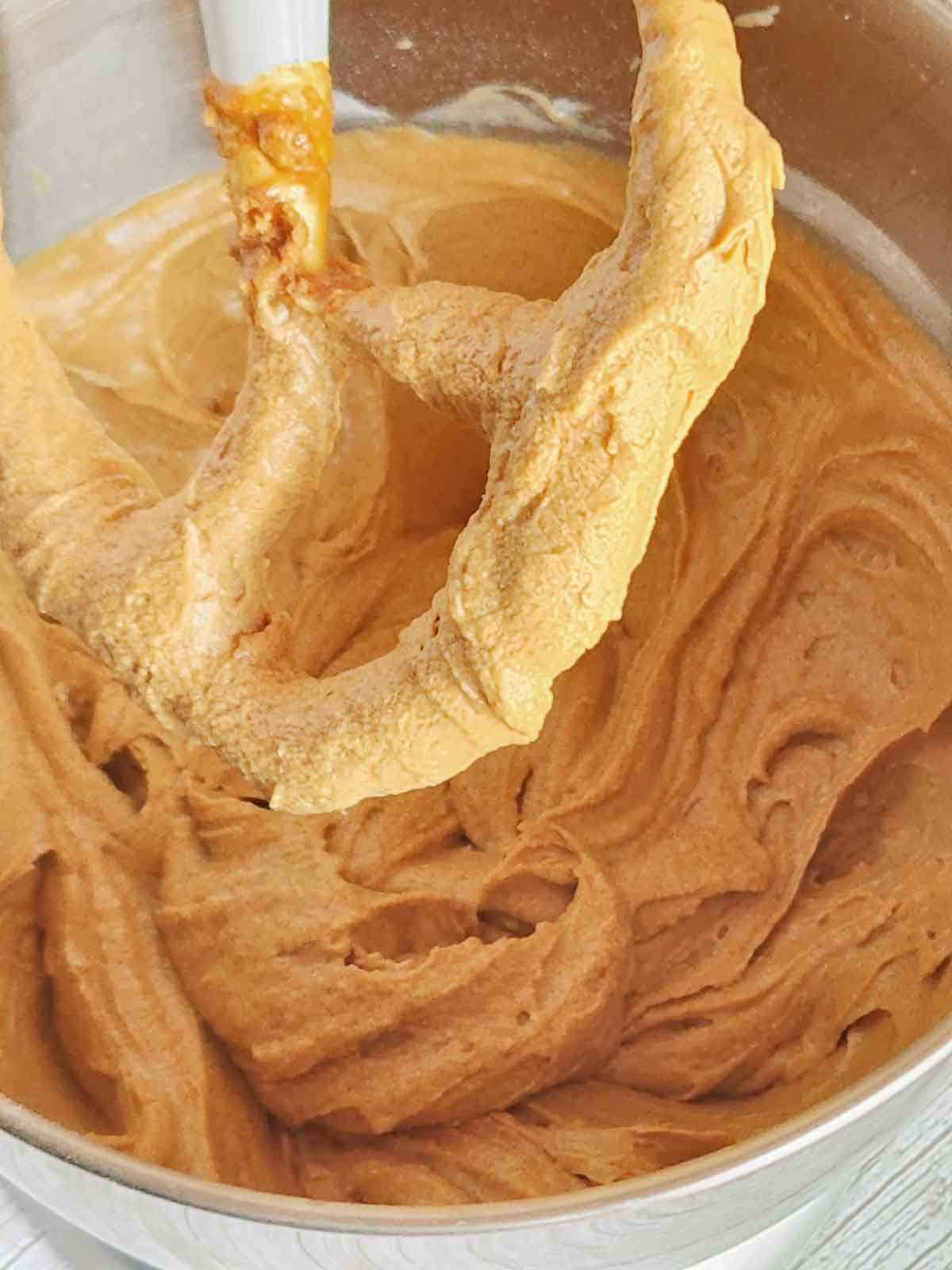 Fluffy soft gingerbread cupcake batter on the paddle attachment of the stand mixer.