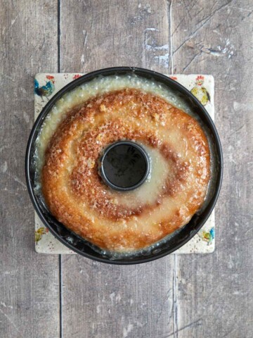 Baked cake with glaze poured over it in the Bundt pan.