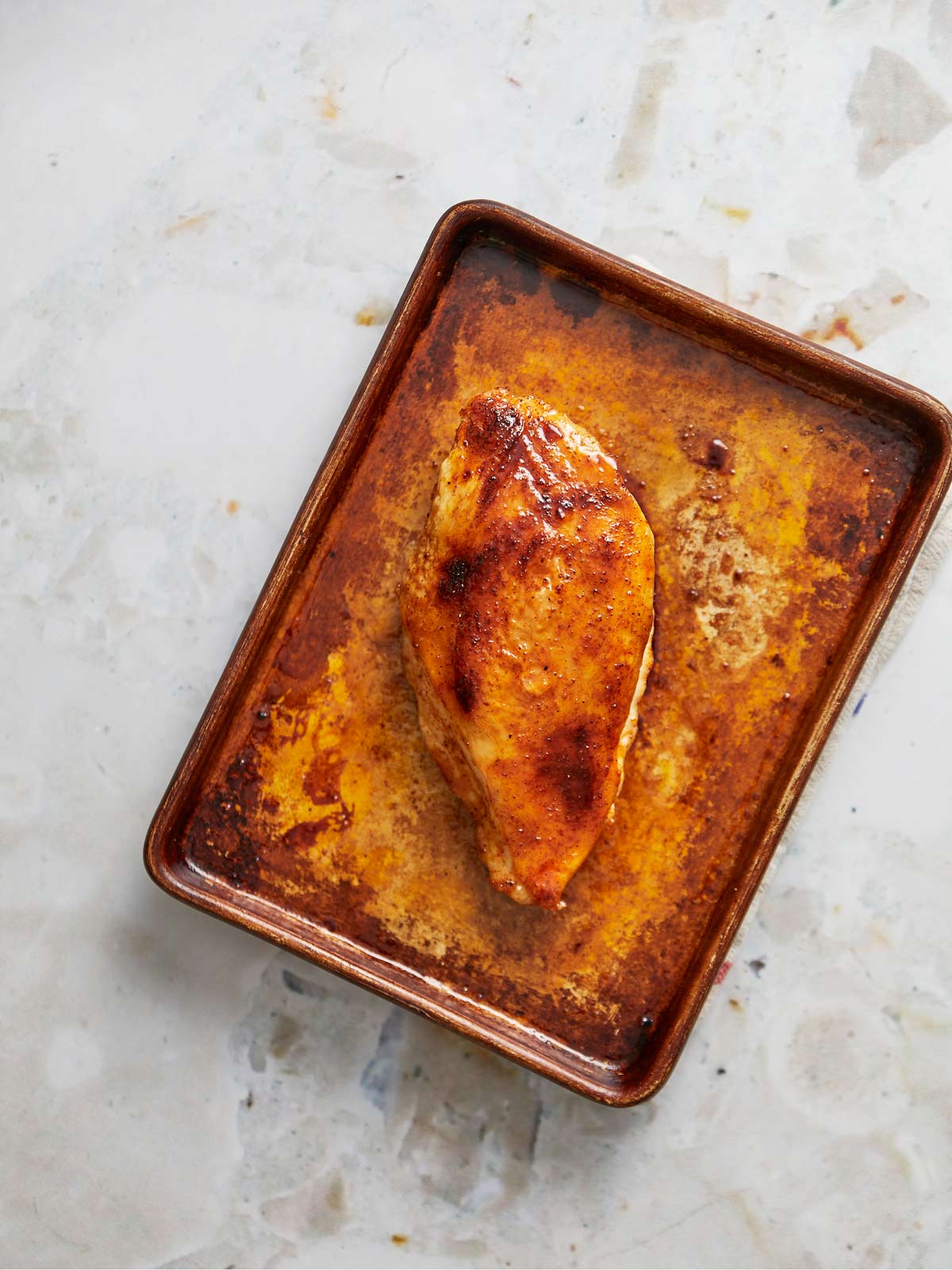 Sheet pan with chicken brushed with hot honey and broiled.