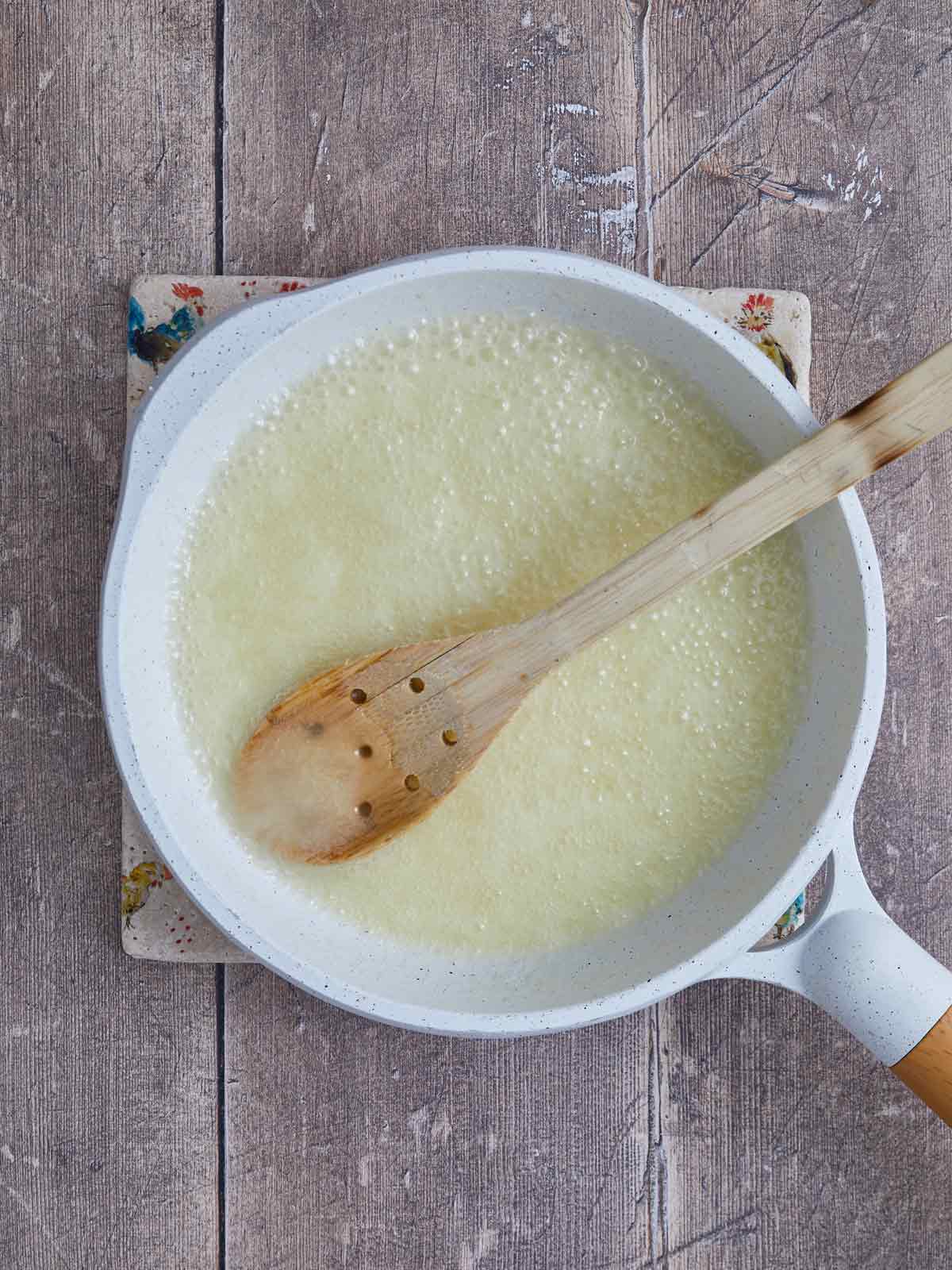 Glaze ingredients boiling in a saucepan.