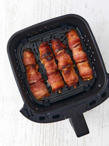 Golden brown bacon on top side of the chicken skewers in the air fry basket.