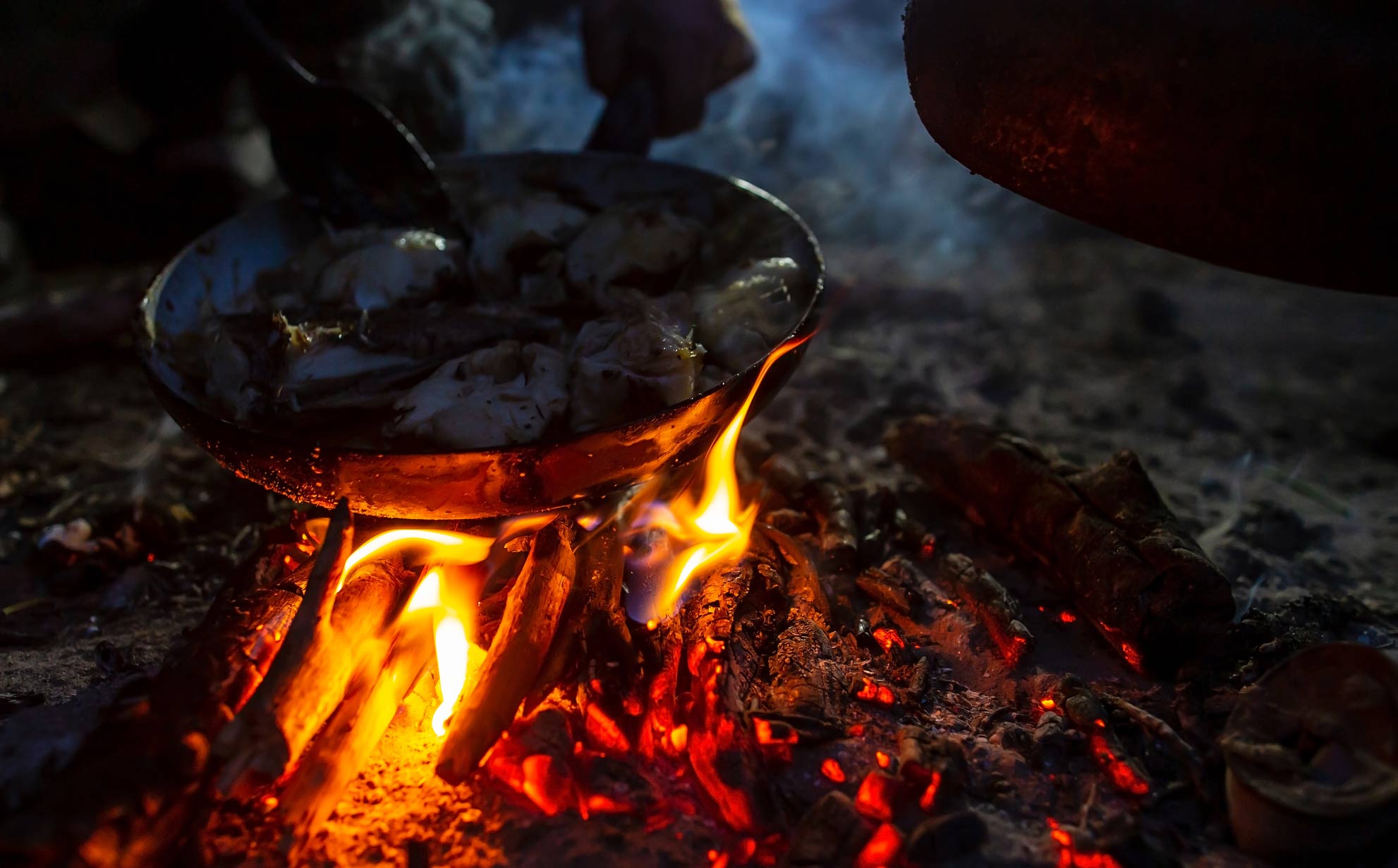 cast iron skillet over a campfire.