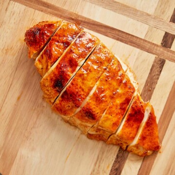 Sliced chicken breast on cutting board.