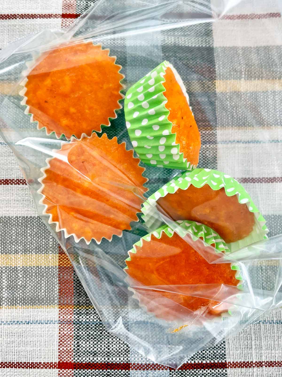 muffin cups with frozen persimmon pulp in a plastic bag.