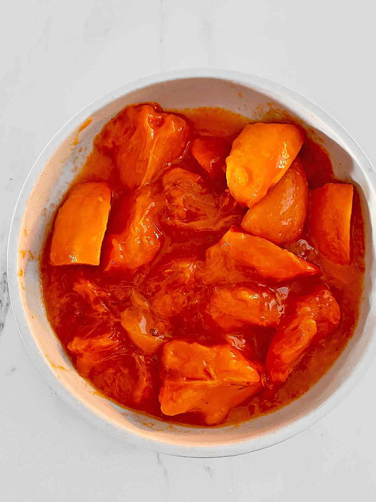 Quartered persimmons in a bowl.