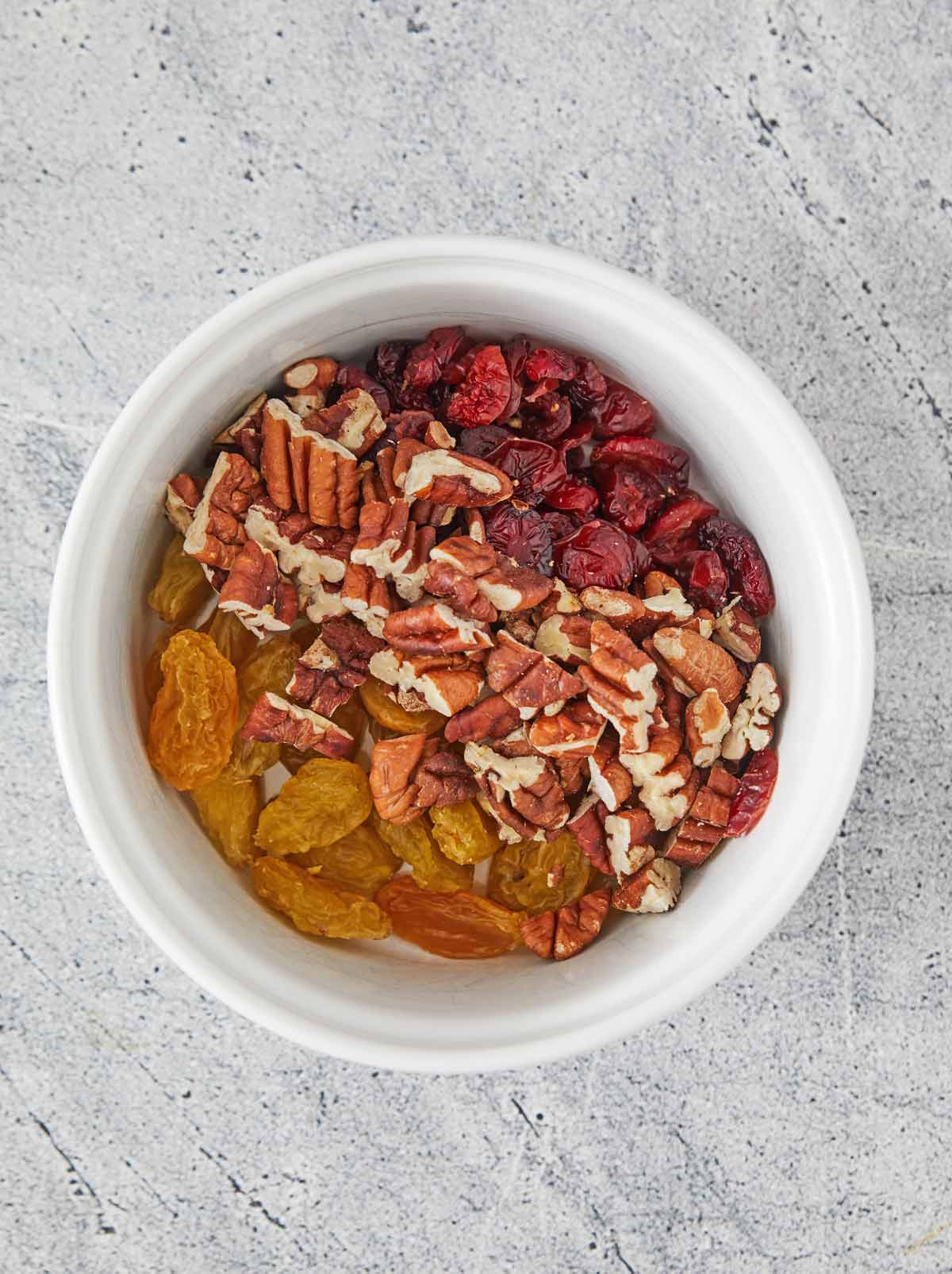 Bowl with pecans, raisins, and cranberries.