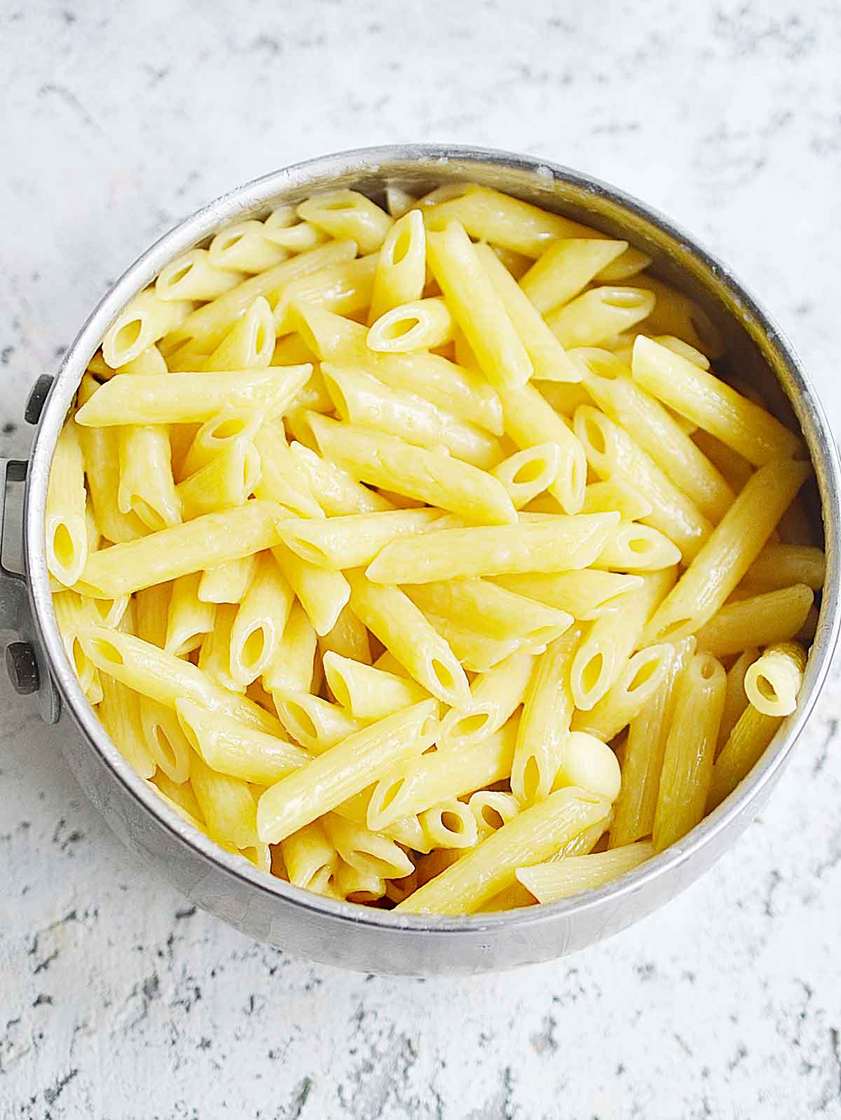 Cooked penne pasta in a pot.