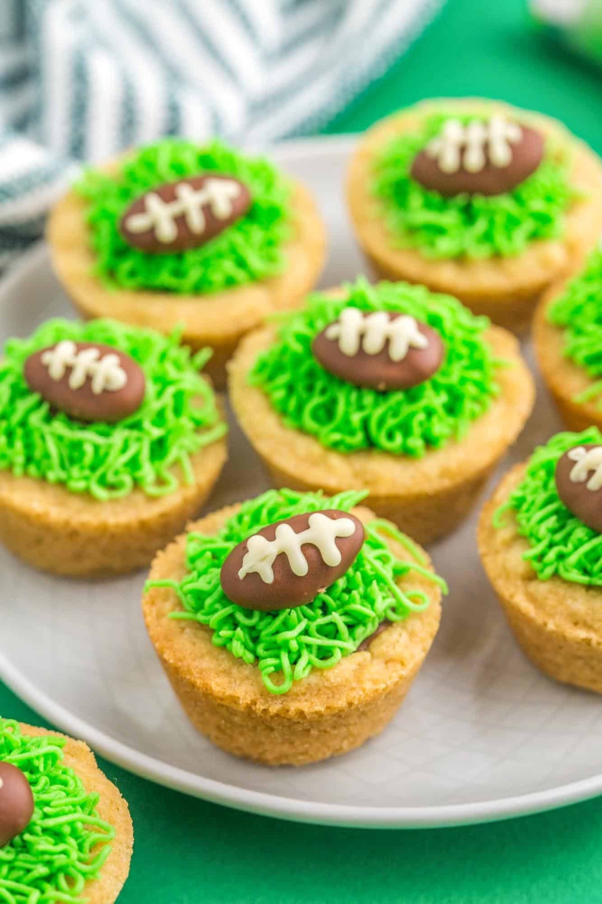 Cute little cookie cups with grass and football piped on top.