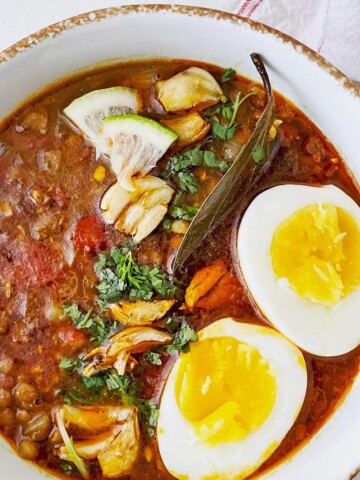 Bowl of lentil soup with boiled eggs.