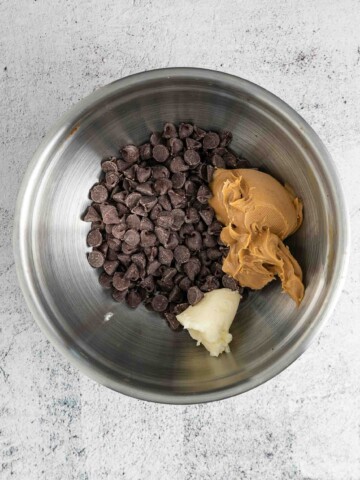 Mixing bowl with chocolate chips, peanut butter, and butter.