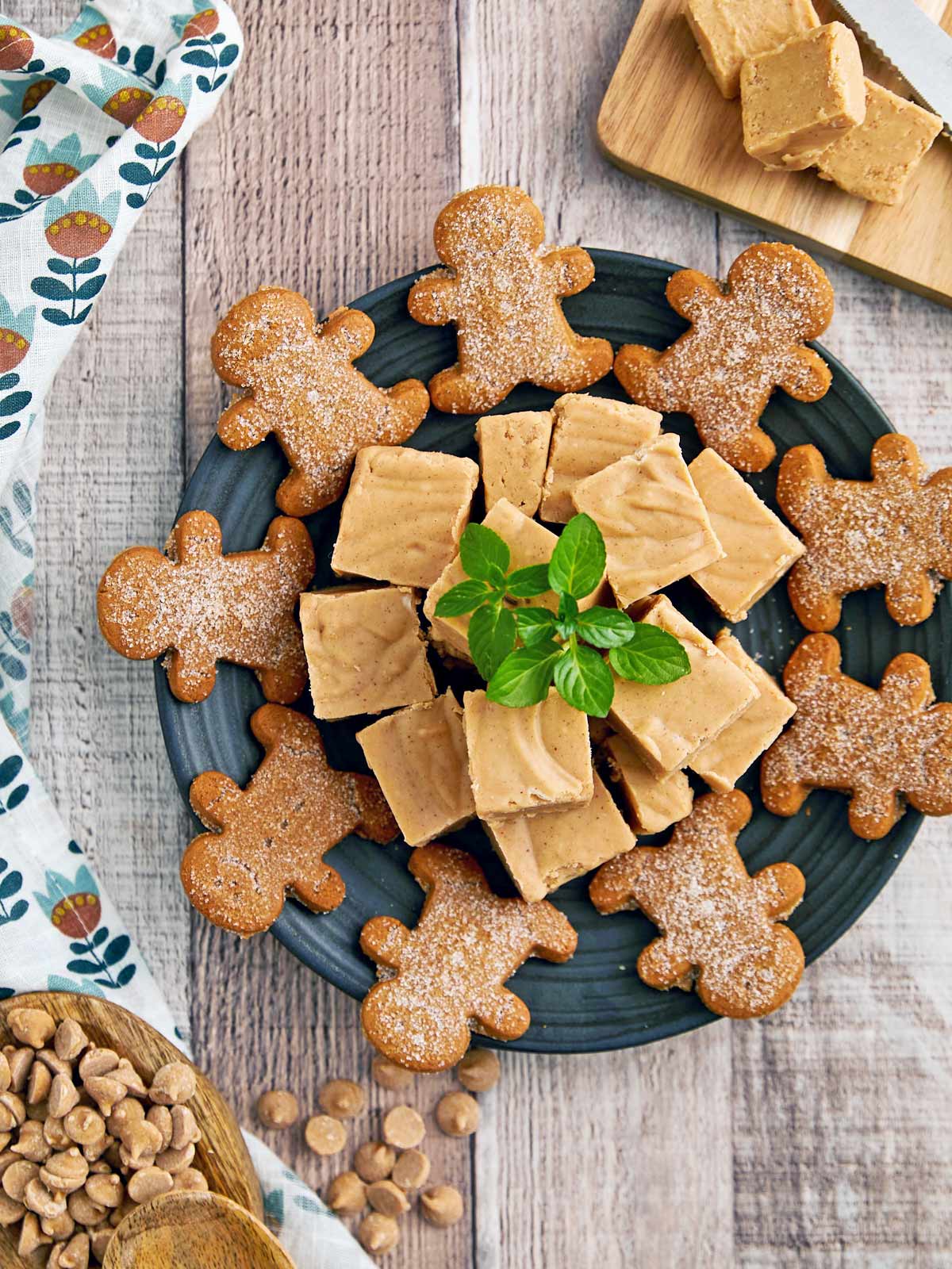 Plate of peanut butter fudge surround by gingerbread men.