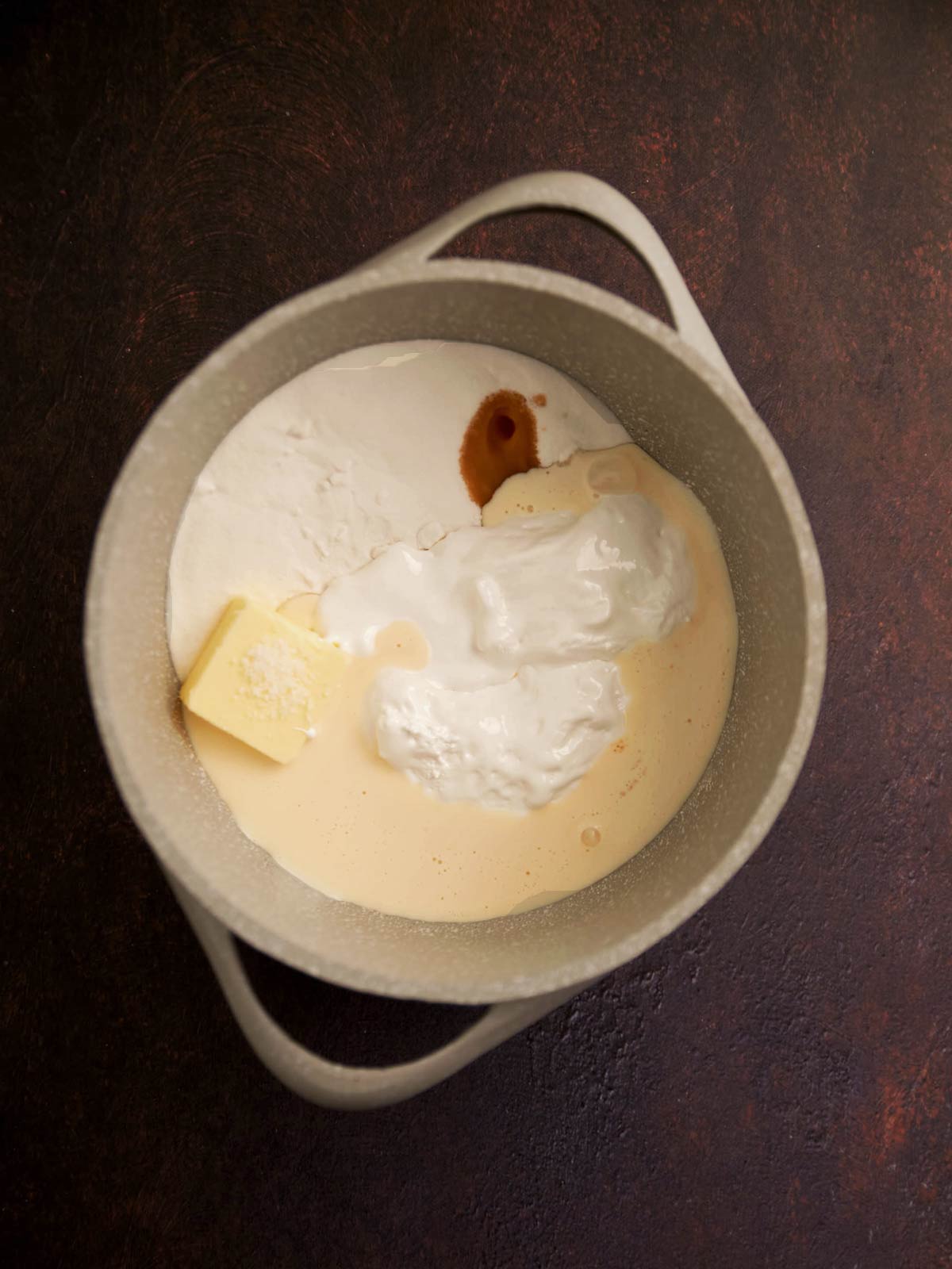 Pot with marshmallow cream, sugar, vanilla, evaporated milk, and butter.