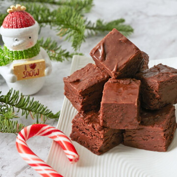 A plate of chocolate fudge with holiday adornments.