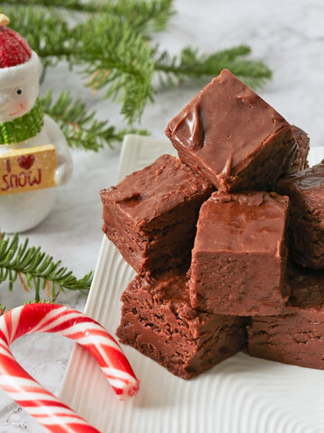 Plate of pieces of fudge and holiday decorations.