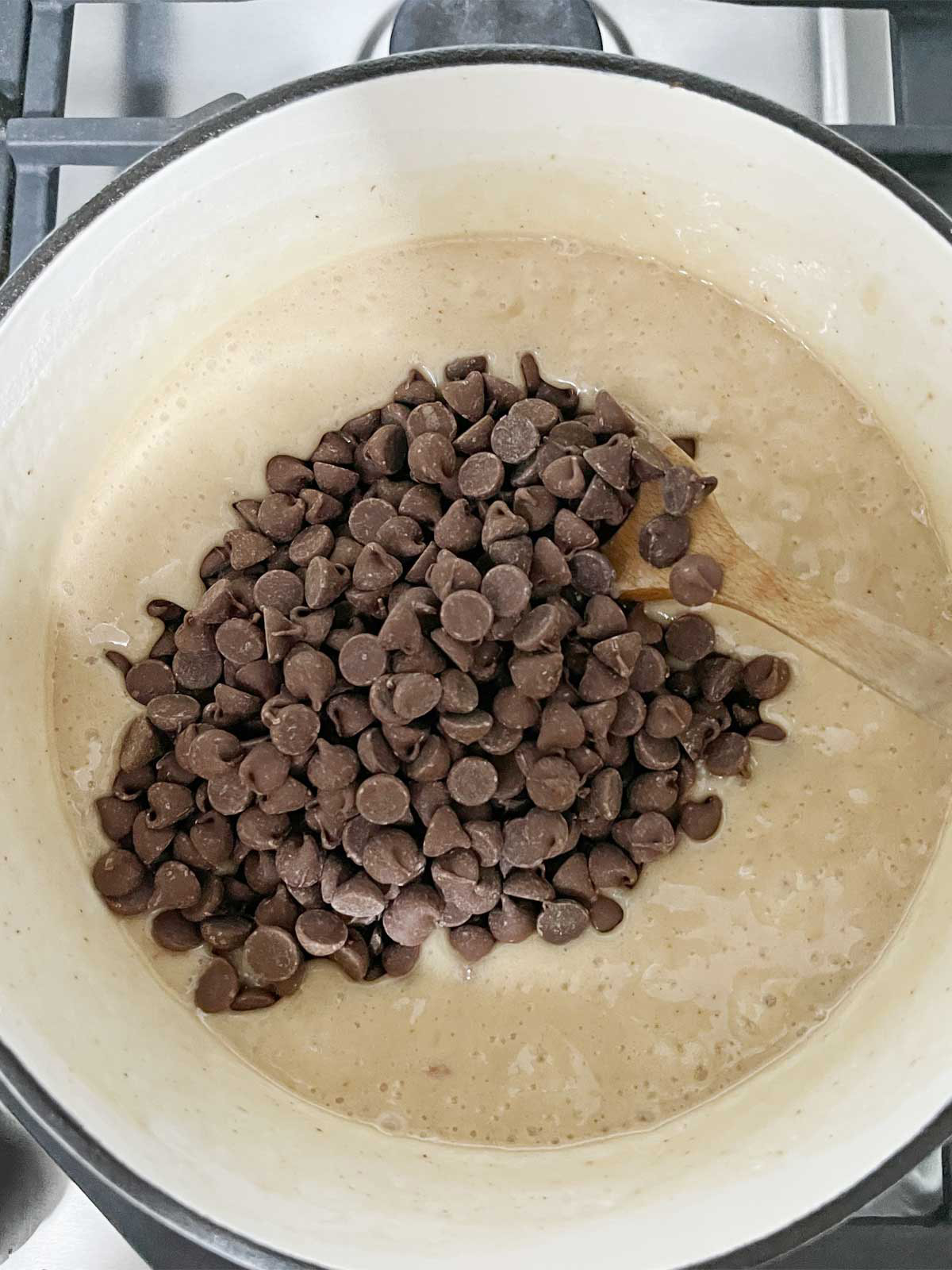 Chocolate chips poured into hot bubbling sugar mixture.
