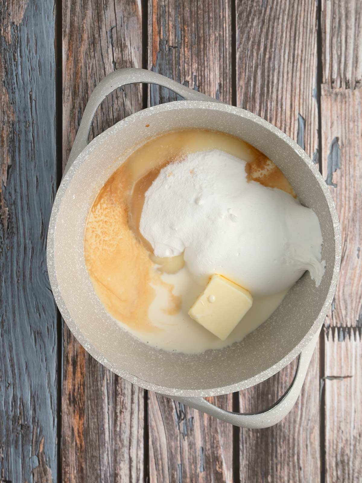 Pot with sugar, butter, marshmallow creme, vanilla, and evaporated milk.
