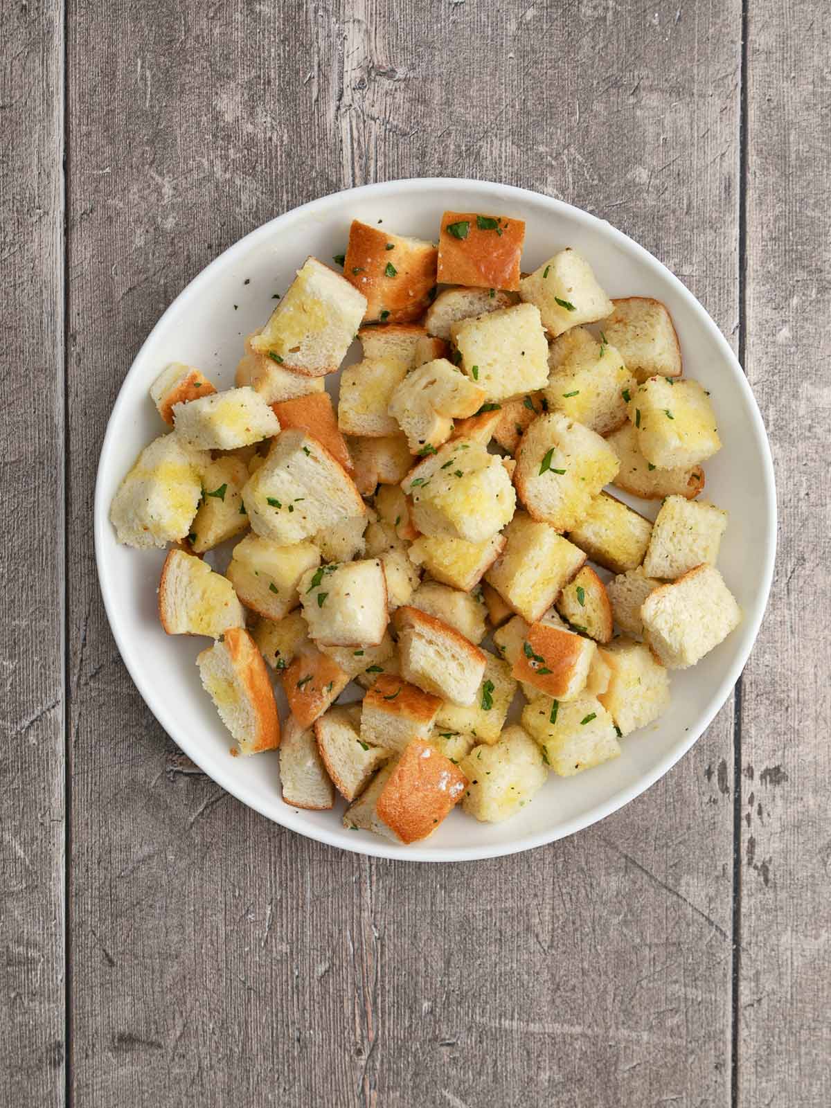 Seasoned bread cubes with oil and butter.