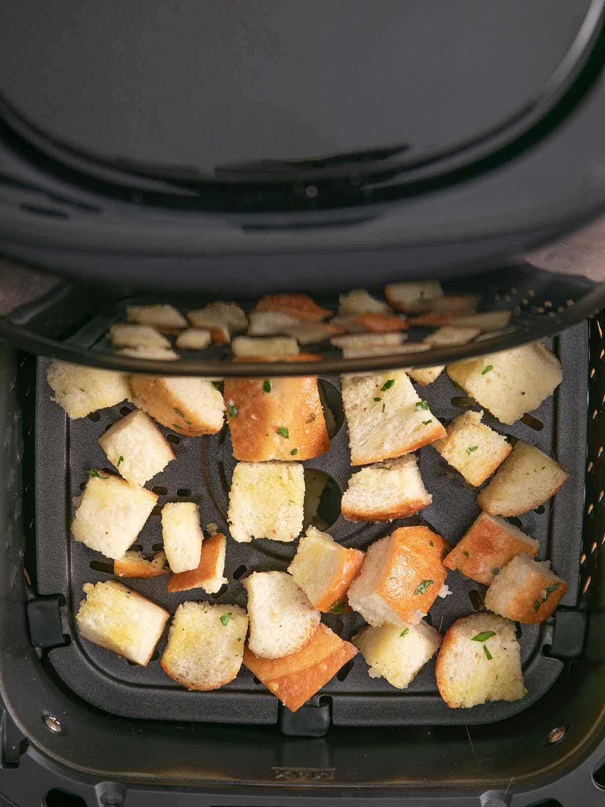 Bread cubes going into the sir fryer.
