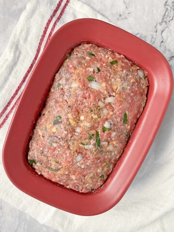 Uncooked meatloaf in loaf pan.
