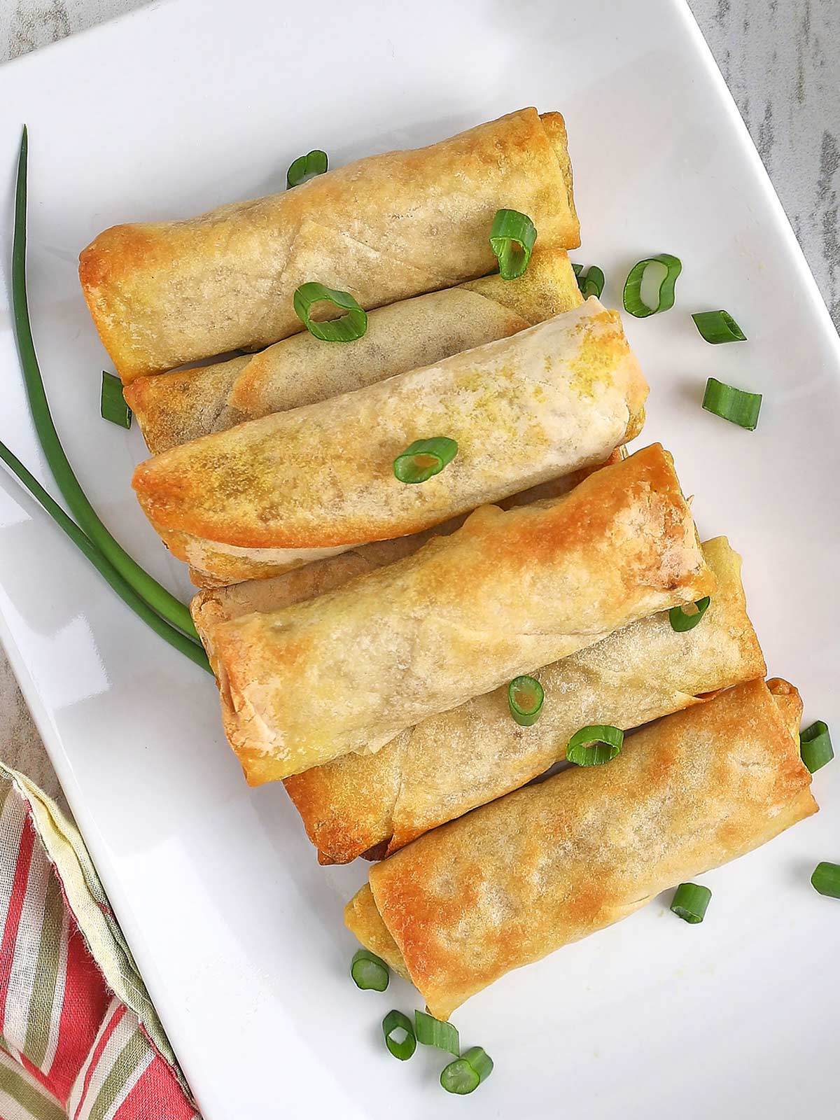 Serving tray with fully cooked lumpia, ready to serve.