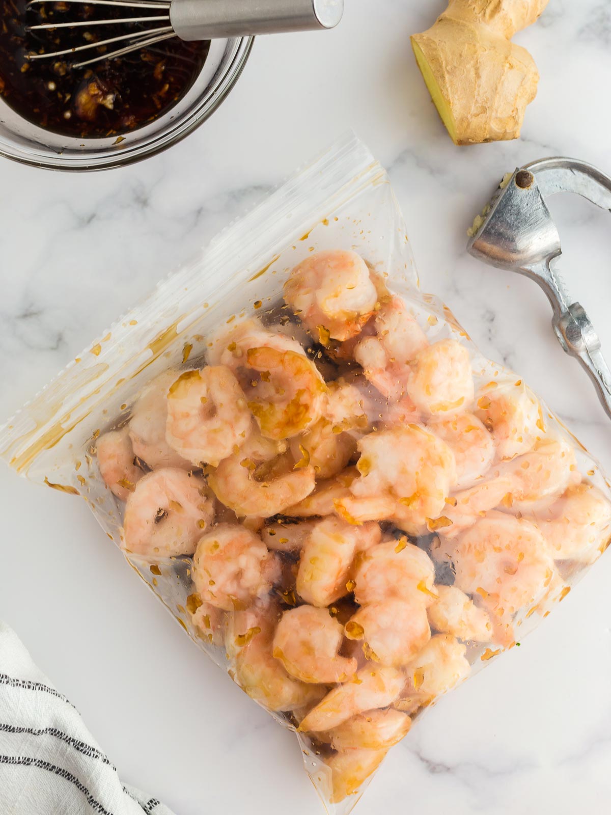 Shrimp and marinade in a zip top bag.