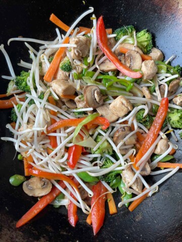 Bean sprouts added to the hot wok with the chicken and vegetables.