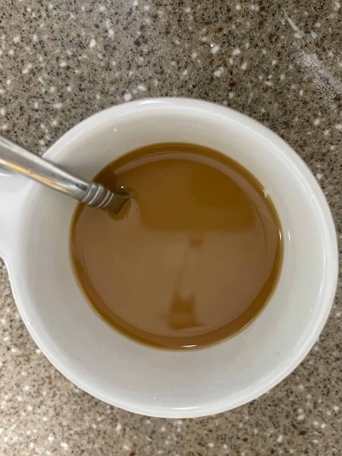 Slurry made of cornstarch, water and soy sauce in small dish.