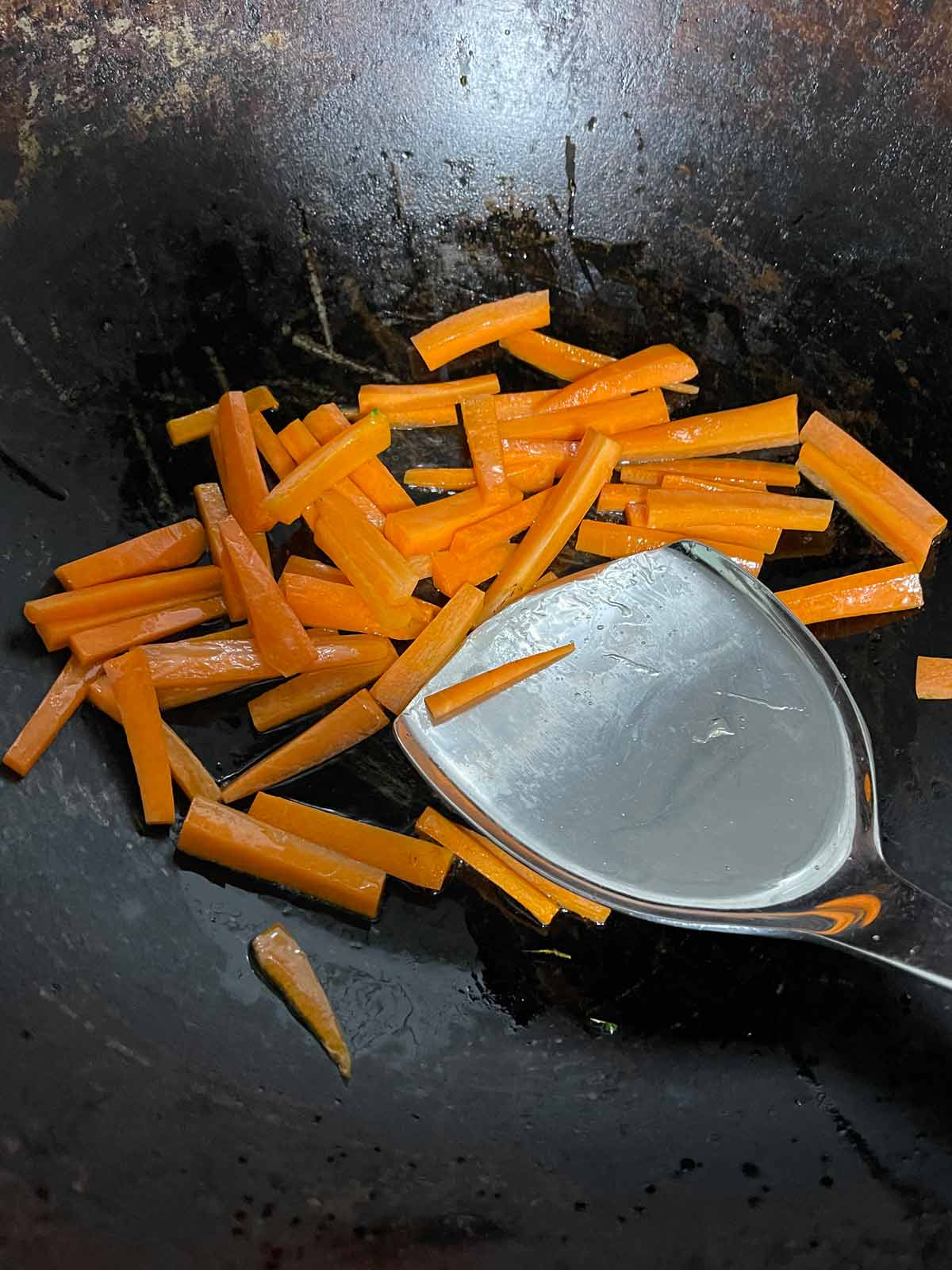 Carrots cooking in a wok.