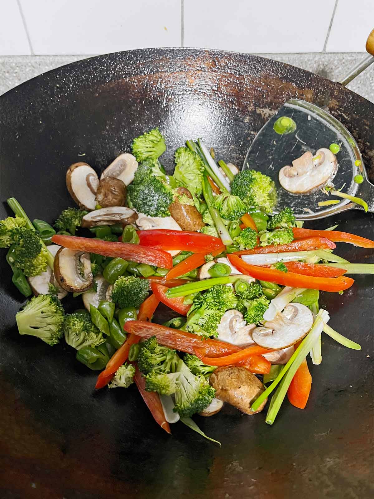 Vegetable being stir fried in a wok.