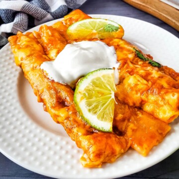 Plate with enchiladas made with frozen taquitos and jarred enchilada sauce.