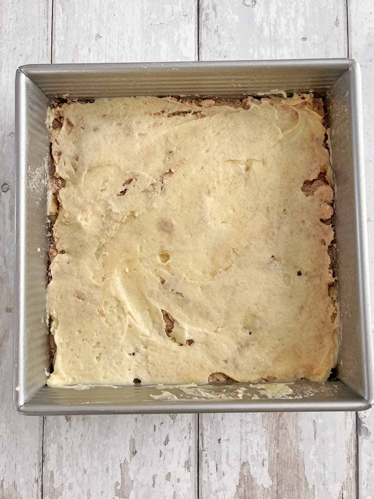 Second half of the batter spread out over the streusel.