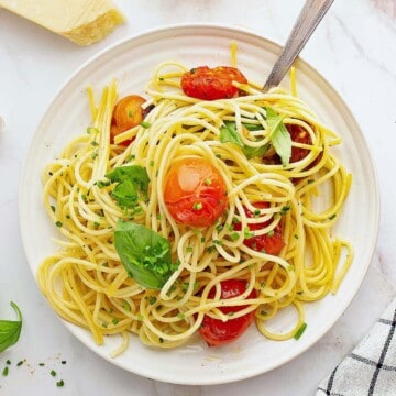 Plate with cooked cherry tomato pasta.