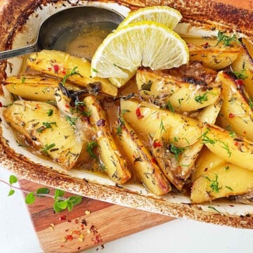 Baking dish with Greek potatoes with lemon.