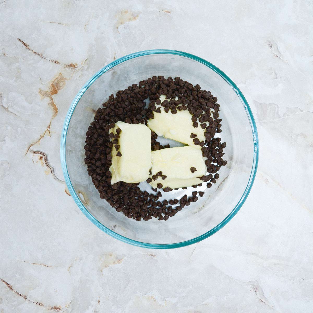 Bowl with chocolate chips and butter.