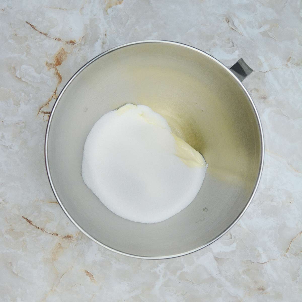 Mixing bowl with sugar and butter.