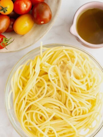 Bowl of cooked angel hair pasta.