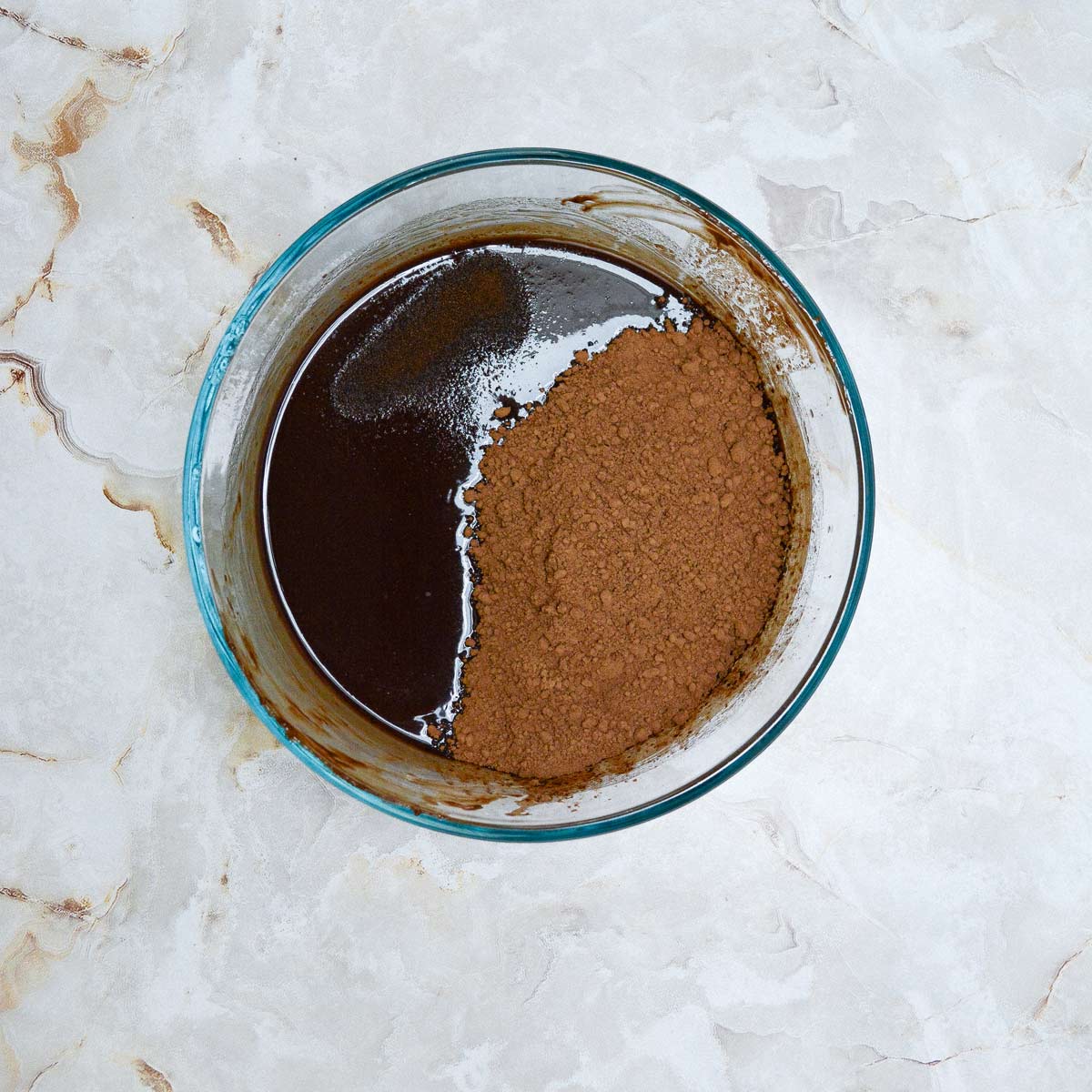Bowl of melted chocolate with cocoa powder added.