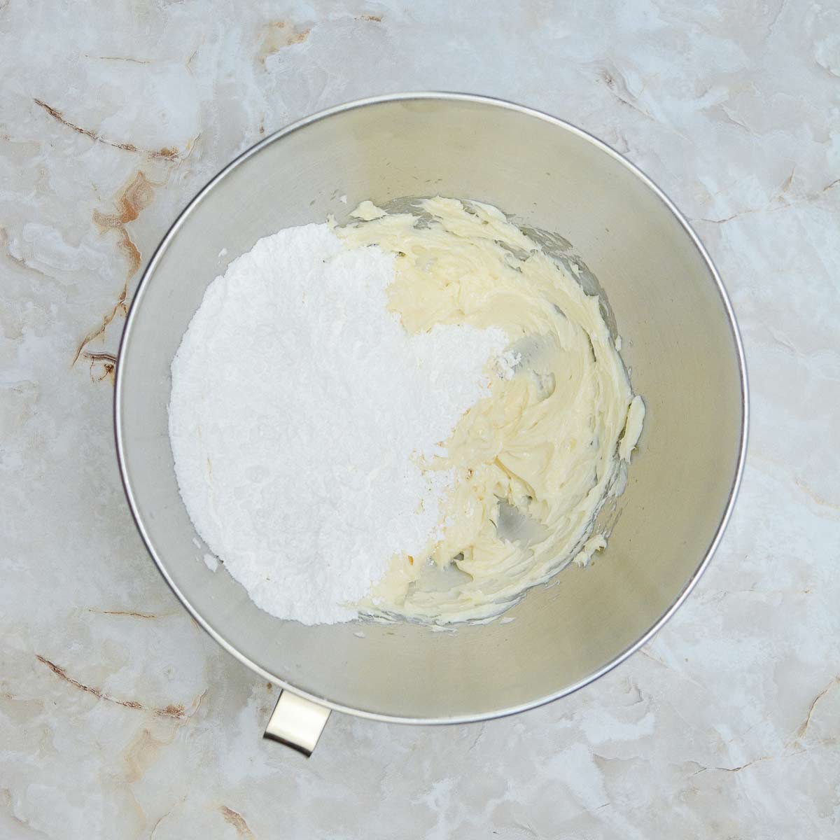 Powdered sugar added to the mixing bowl.