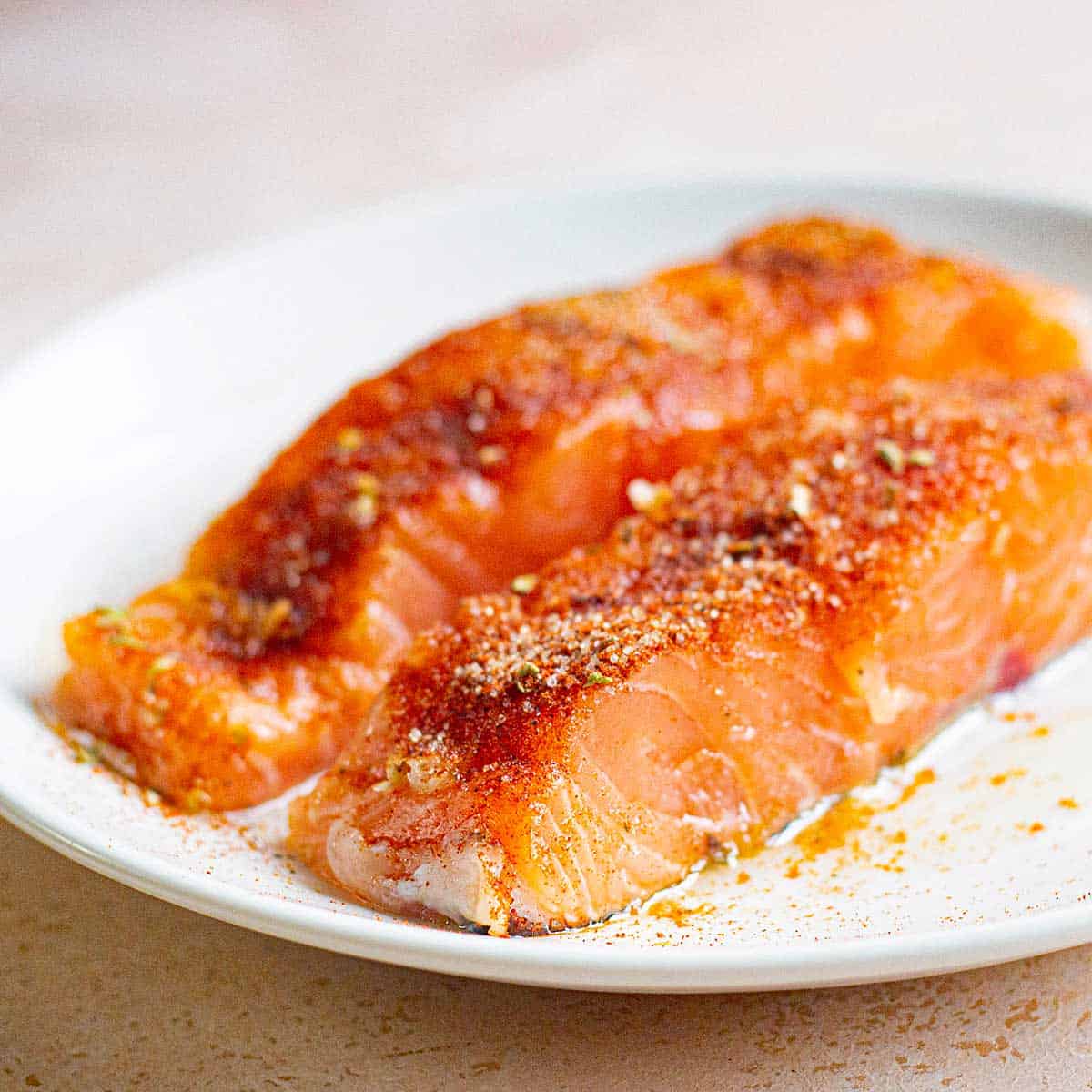 Plate with 2 seasoned salmon filets.