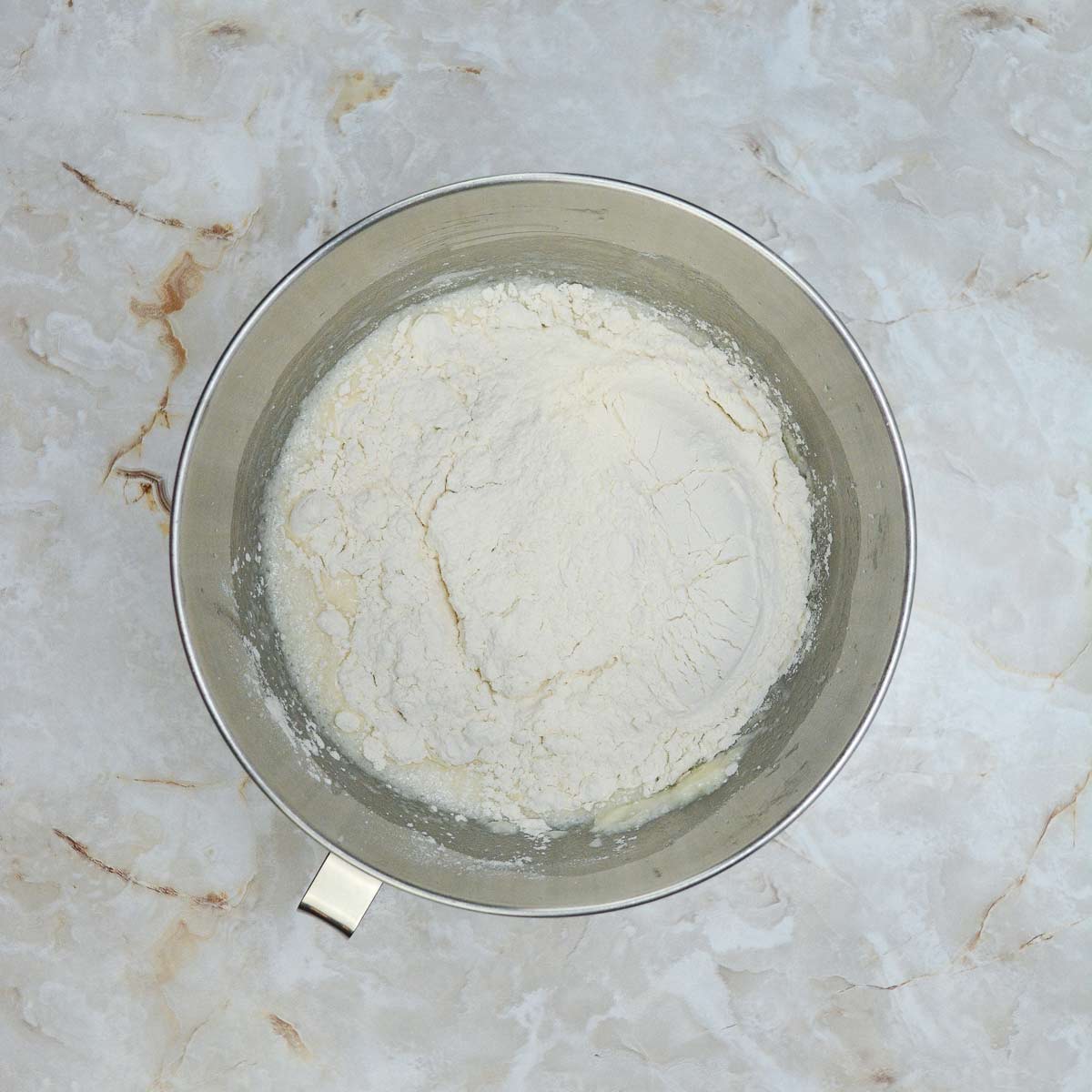 Flour added to the mixing bowl.